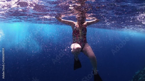 Woman Swimming In Tropical Blue Sea Beside Coral Reef
