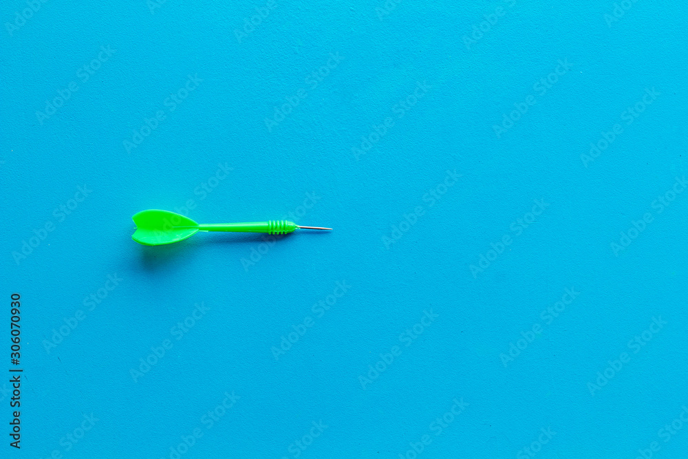 Plastic dart or arrows for darts game on blue background top view copy space Plastic dart or arrows for darts game on blue background top view copy space