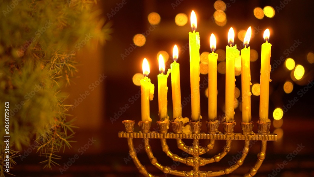 Fototapeta premium The seventh Night of Hanukkah. Seven lights in the menorah. Chanukah is the Jewish Festival of Lights