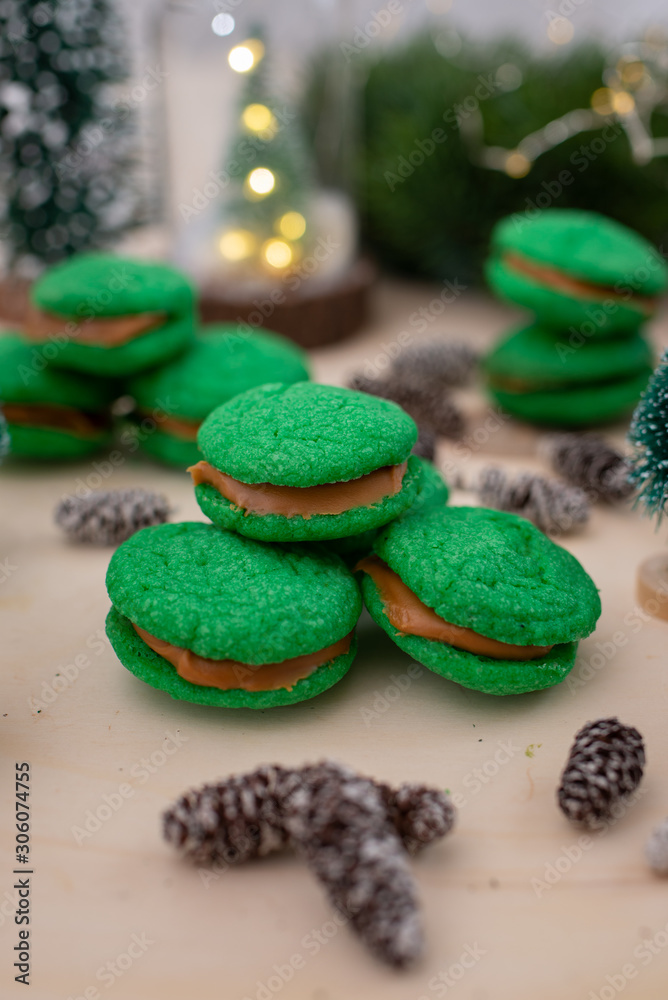 Home made green christmas sugar cookies on a festive christmas background Home made green christmas sugar cookies on a festive christmas background