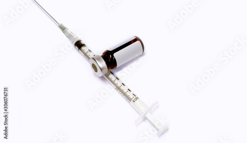 3 ml. Ampule of drug and plastic syringe with medical needle on white background.