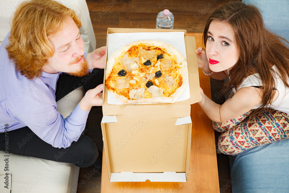 Couple about to eat pizza and drinking beer Couple about to eat pizza and drinking beer