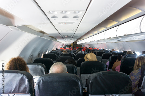 Inside of airplane cabin with people while traveling