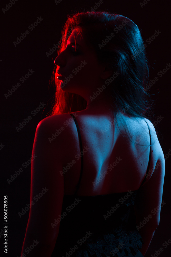 beautiful girl in the light of colored lamps