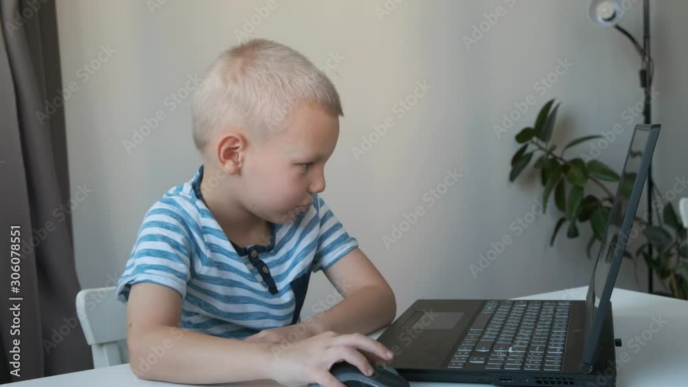 Boy working on a computer, programming, learning or playing Boy working on a computer, programming, learning or playing
