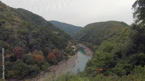 High view, tour riverboats drift down quiet Katsura River, Arashiyama photo