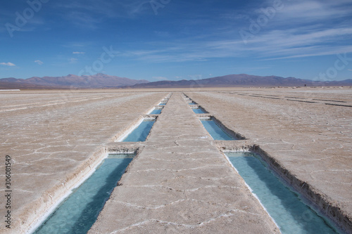 Blue water swimming pool dug in the salt desert of the Salinas Grandes, Argentina