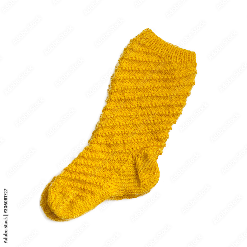 Fototapeta premium Warm knitted yellow female sock closeup. Isolate
