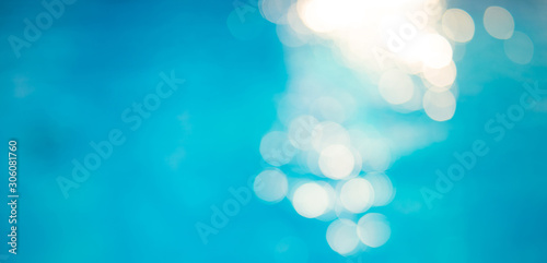 Bokeh light effects over a rippled, blue water background