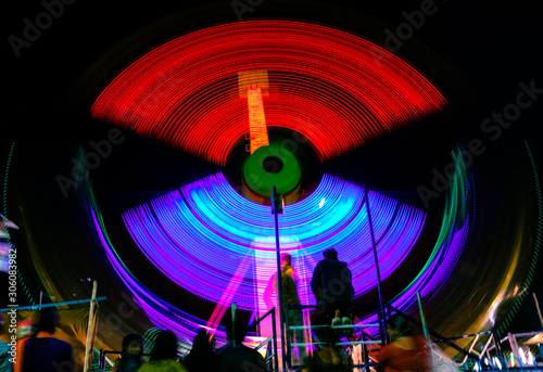 Spinning ferris wheel at night.