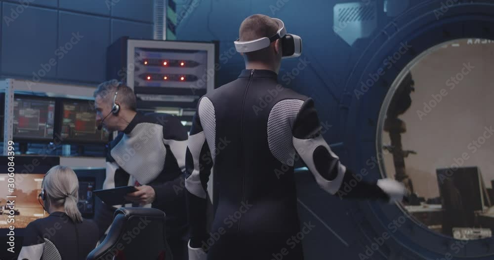 Astronaut controlling Mars rover with VR device Astronaut controlling Mars rover with VR device