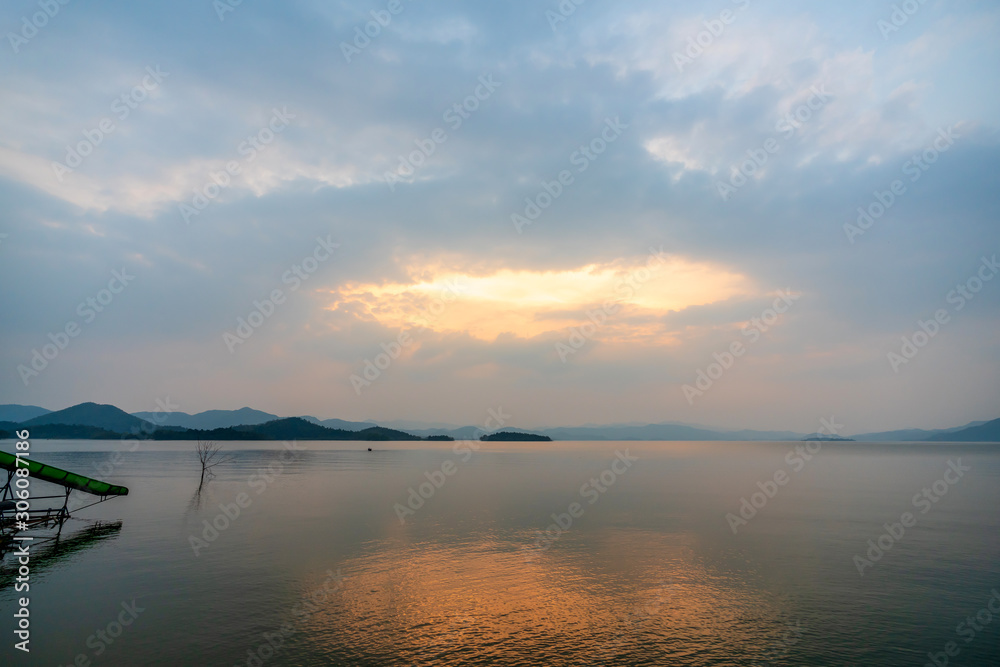 Naklejka premium beautiful blue sky green forest mountains lake view at Kaeng Krachan National Park, Thailand. an idea for backpacker hiking on long weekend or a couple, family holiday activity camping relaxing