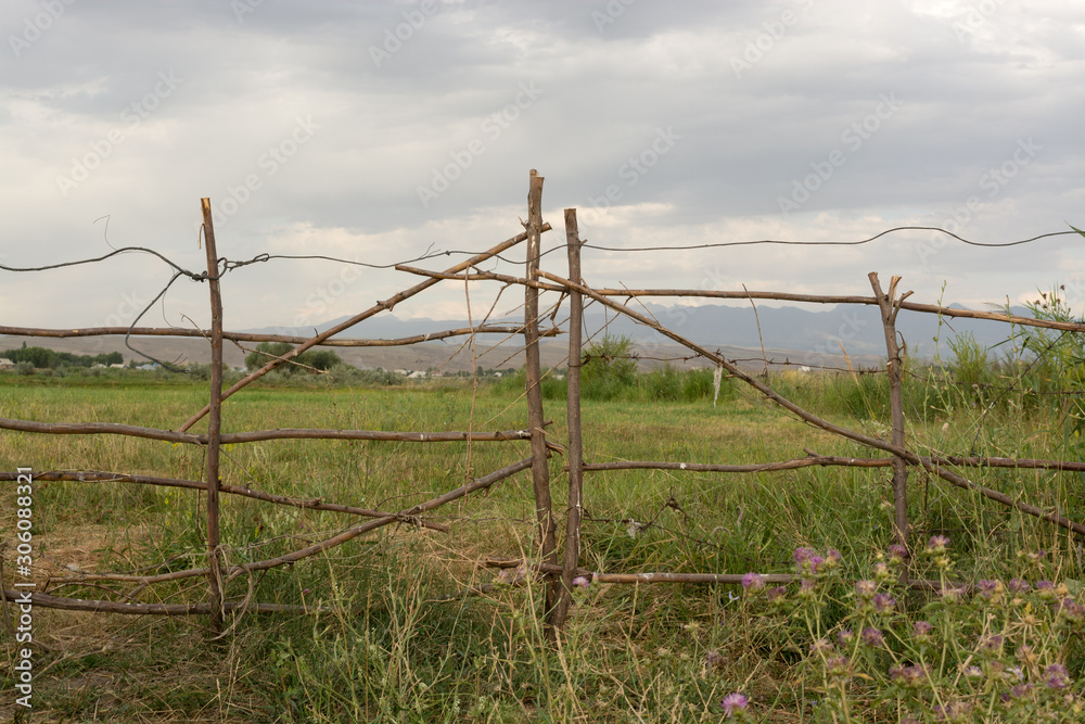 Wooden fence. The territory is peasant. Farm