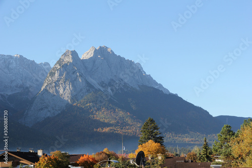 View of the Bavarian town of Garmisch Partenkirchen with moutains in the background on a sunny morning in Autumn
