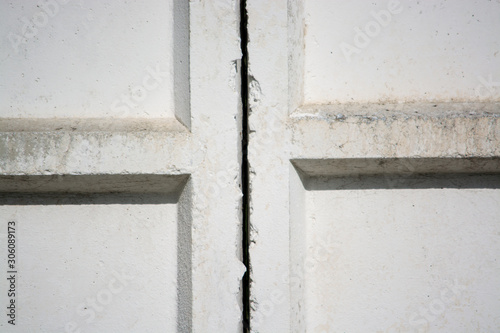 White concrete wall of the Soviet era. The junction between the plates. Fragment of the wall.