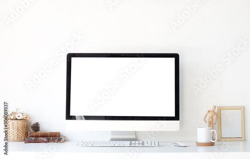 Work place concept Mockup blank screen Office desk Workspace stuff with notepad, laptop and coffee cup mouse notepad shot.