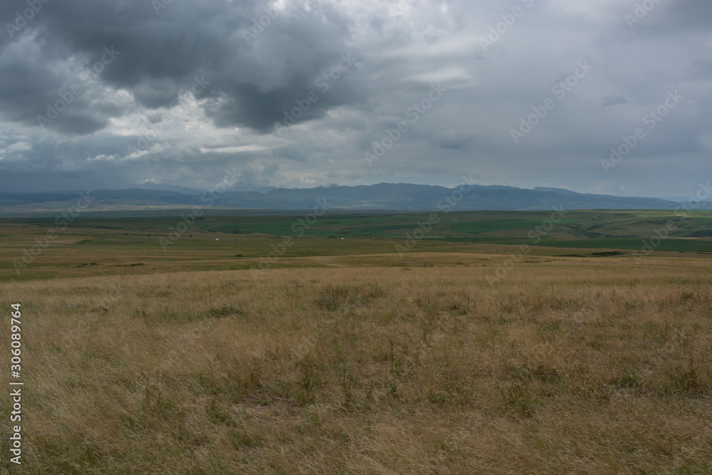 Clouds are moving over the hill. Kazakhstan. Mountains 