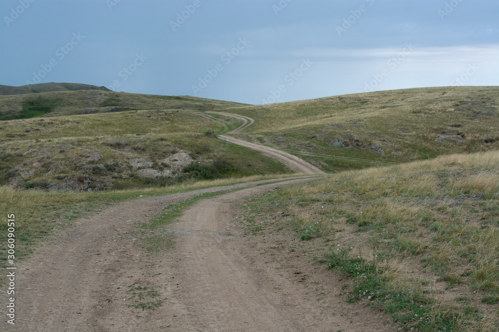 Green, grassy hill. The path, the road on the hill. Summer season. Nature Green, grassy hill. The path, the road on the hill. Summer season. Nature