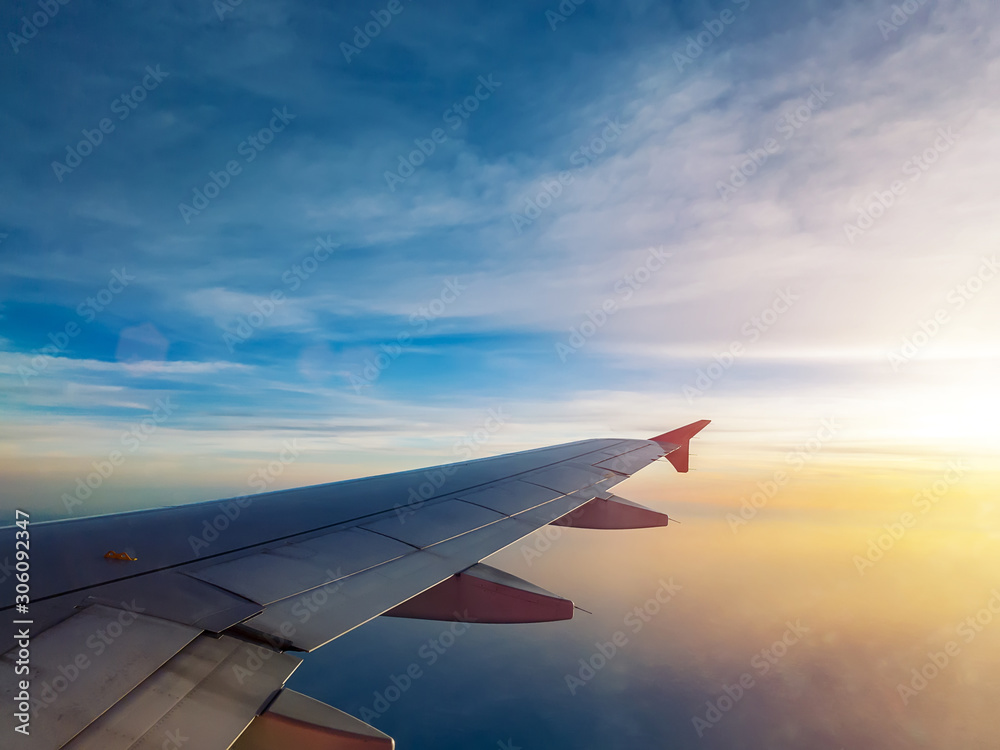 Fototapeta premium sunset sky as seen through window of airplane, plane window. travel and vacation concept