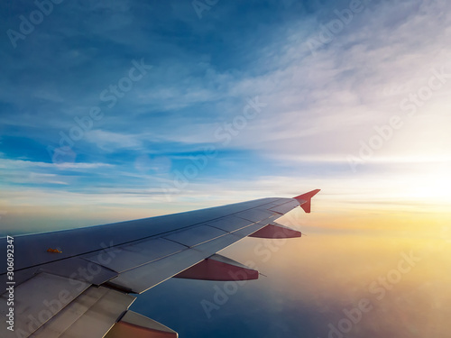 sunset sky as seen through window of airplane, plane window. travel and vacation concept