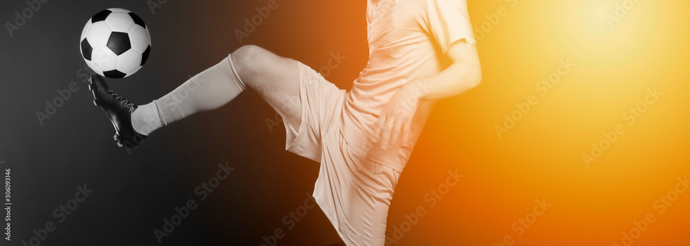 Close Up Legs And Soccer Shoe Of Football Player In Action Kicking Ball Isolated On Black Background Yellow Filter Stock Photo Adobe Stock