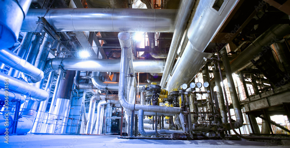 Equipment, cables and piping as found inside of a modern industrial power plant