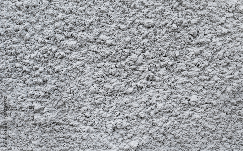Gray plastered wall, patterned background, indented protruding texture 