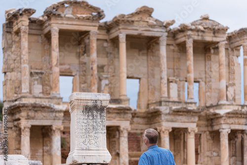 People visiting Celsus Library. Visitors looking at the post in the column. S...