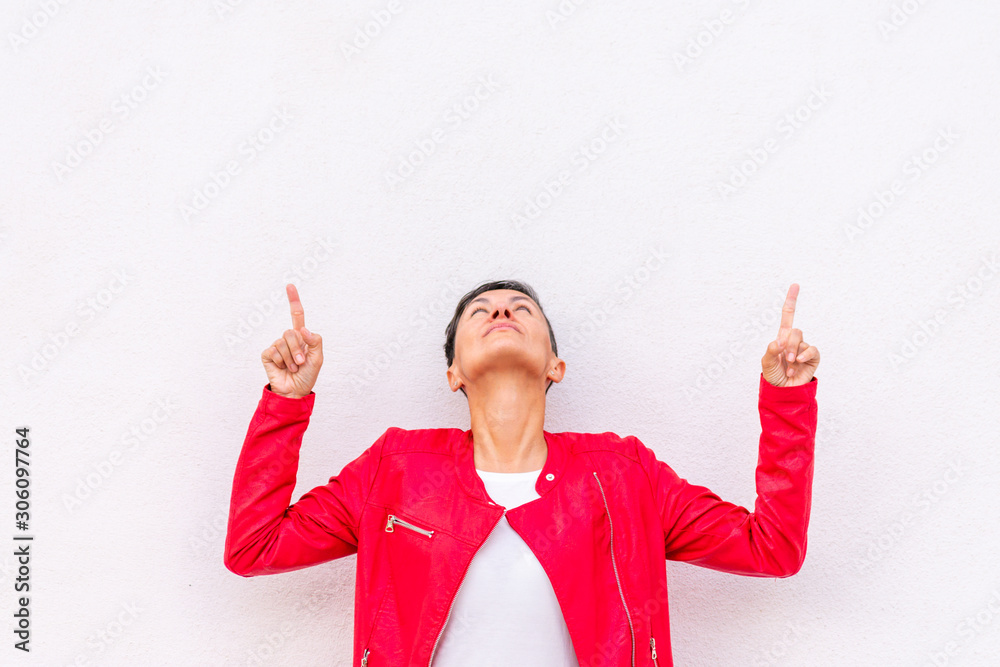 middle aged woman pointing up on white background middle aged woman pointing up on white background