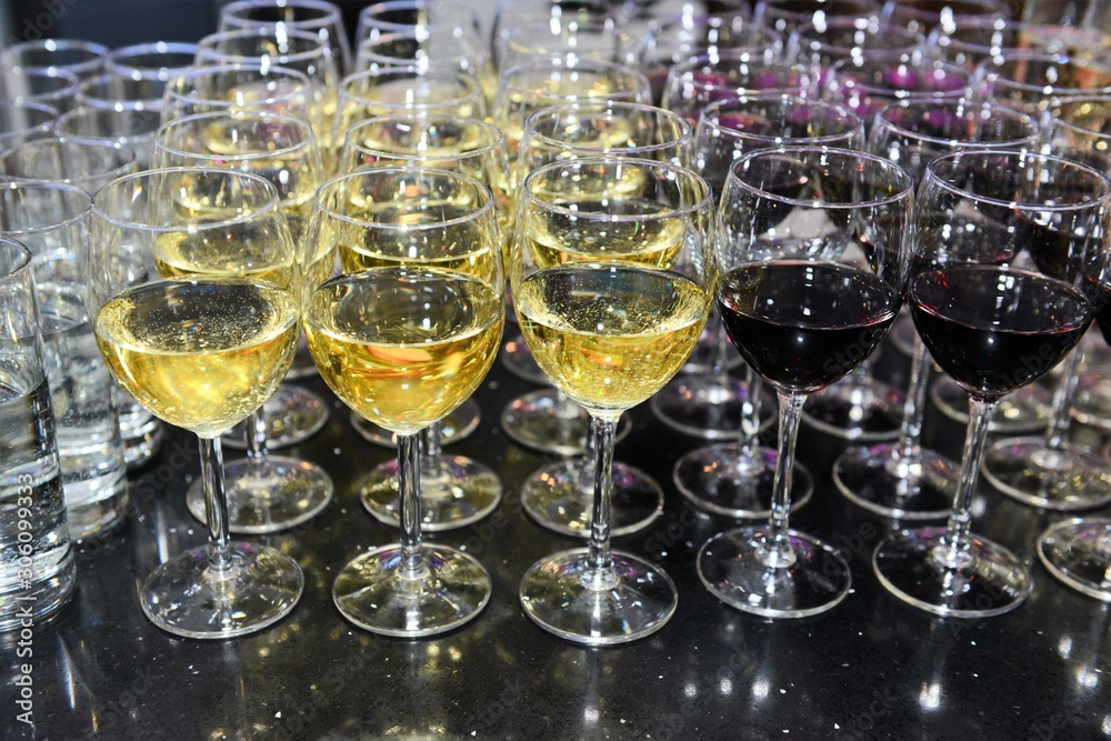 Rows of full champagne, sparkling wine and red wine glasses. Dining, drink. Catering service concept. Rows of full champagne, sparkling wine and red wine glasses. Dining, drink. Catering service concept.