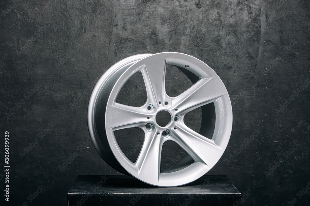 Сar metal rims at the grey background