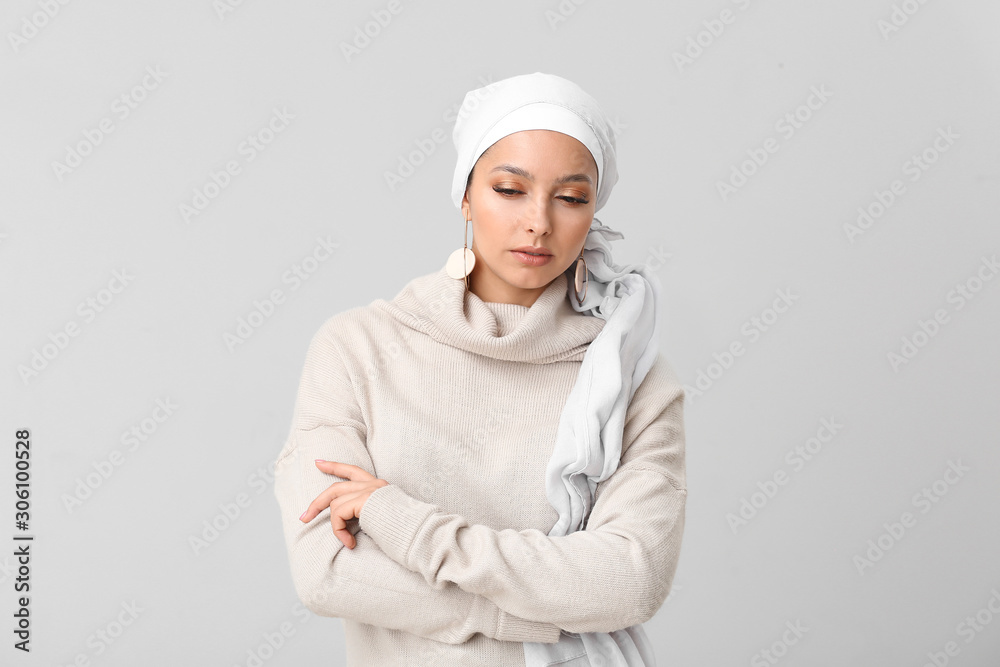 Portrait of beautiful Muslim woman on light background Portrait of beautiful Muslim woman on light background