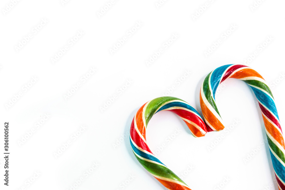 Colorful festive Lollipop in shape of heart on white background selective focus