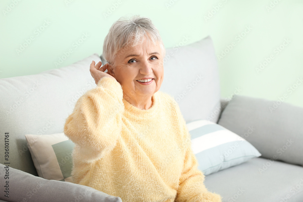 Senior woman with hearing aid at home Senior woman with hearing aid at home