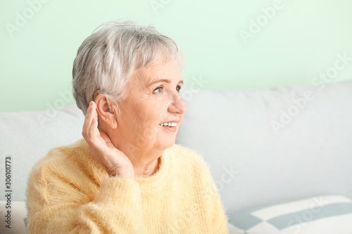 Senior woman with hearing a...