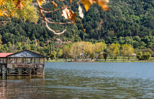 Lake in the forest. Autumn landscape at Golcuk Lake in Odemis, Izmir. Wooden ...