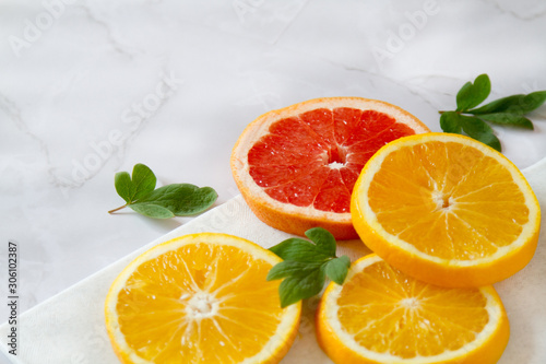 Fototapeta Naklejka Na Ścianę i Meble -  Fresh oranges wallpaper. Healthy fruits - oranges and grapefruits. Brights healthy food on a marble table