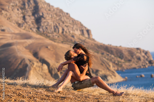 Fotografie, Tablou beautiful girl with a man at sunset.