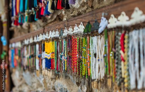 Stand of a street vendor selling anklets and bracelets. © Gken