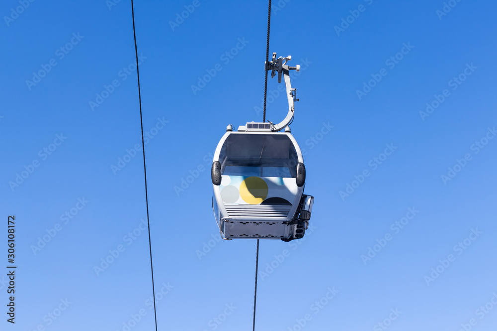 Cableway in the center of the frame against a blue sky Cableway in the center of the frame against a blue sky