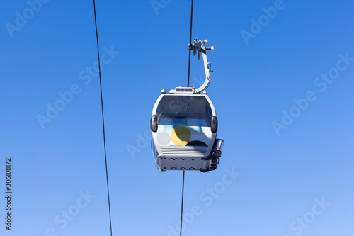Cableway in the center of the frame against a blue sky