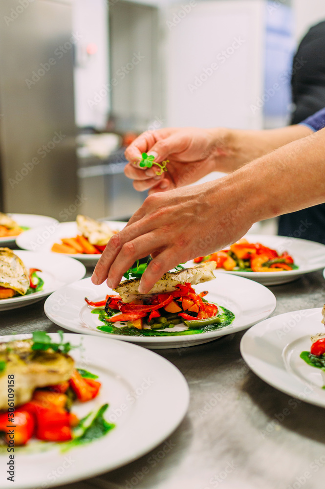 Cooking a delicious main course in the restaurant kitchen. Catering on holiday.