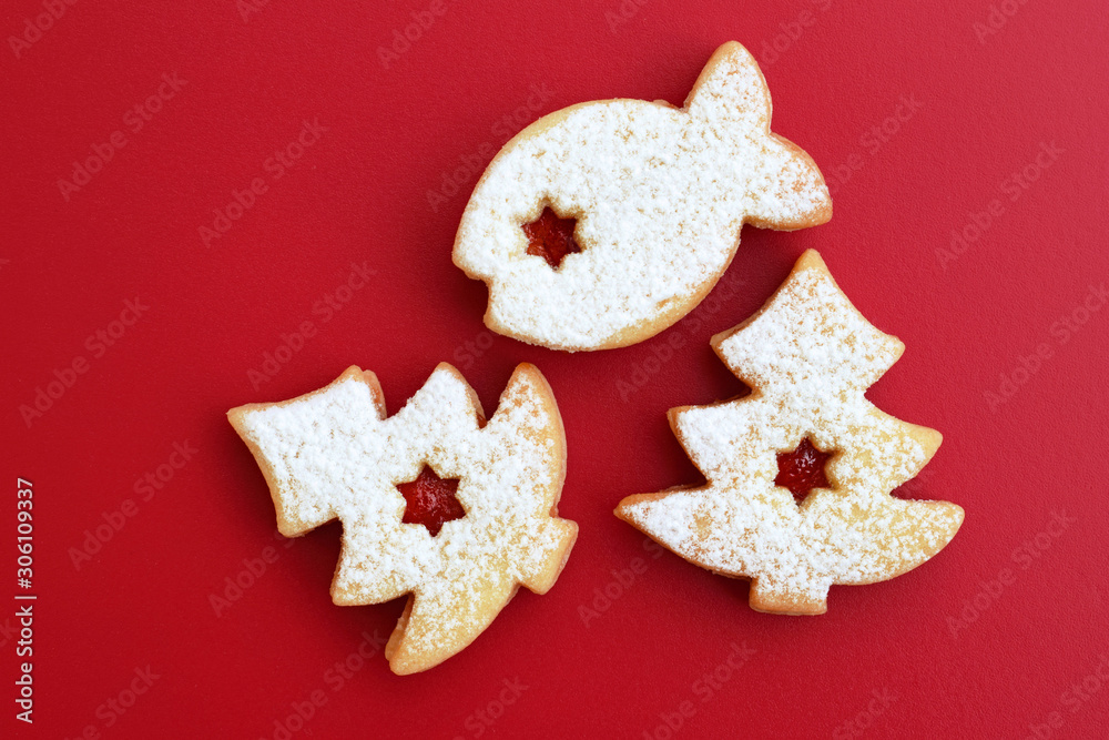 Homemade linzer cookies filled with red jam and dusted with powdered sugar Homemade linzer cookies filled with red jam and dusted with powdered sugar