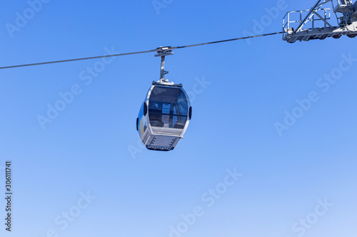 Cabin cableway on a background of blue sky