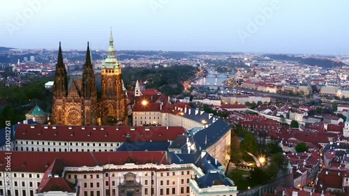 Wallpaper Mural Aerial view of St. Vitus Cathedral in Prague at twilight. Drone flying at distance famous cathedral in middle of Prague castle, Lateral moving above buildings with red tiled roof at evening Torontodigital.ca