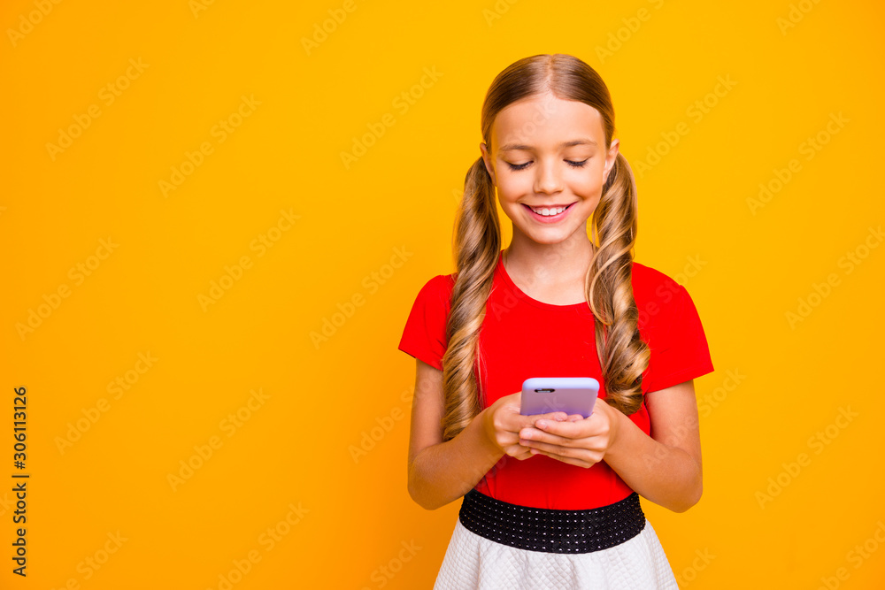 Photo of nice small lady holding telephone hands young influencer writing new post for own popular blog wear casual red white dress isolated bright yellow color background Photo of nice small lady holding telephone hands young influencer writing new post for own popular blog wear casual red white dress isolated bright yellow color background