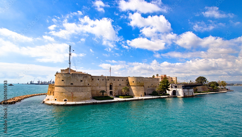 Aragonese Castle of Taranto and revolving bridge on the channel between Big and Small sea, Puglia, Italy, Blue sunny sky 