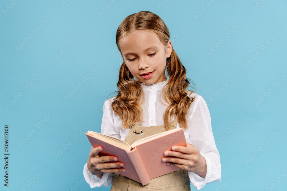 cute kid reading book isolated on blue with copy spaxe cute kid reading book isolated on blue with copy spaxe
