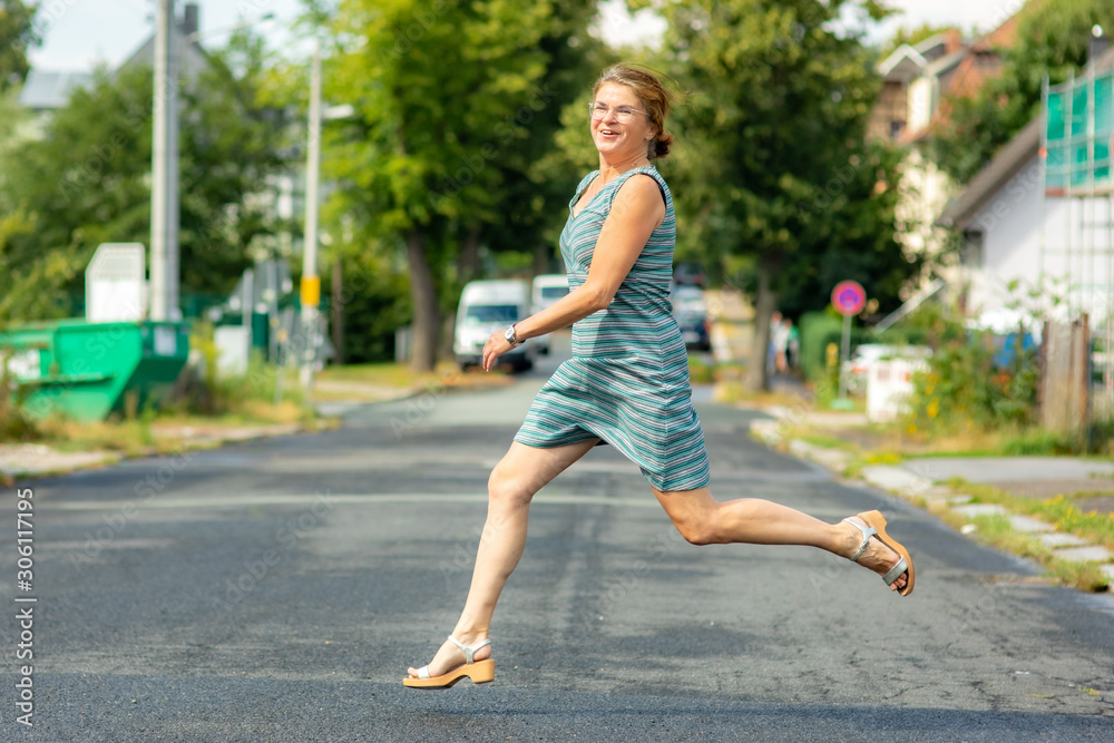 Woman is running and jumping in the street