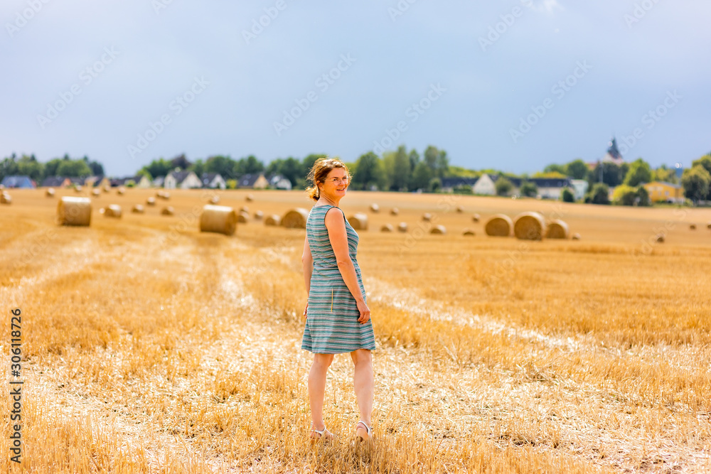 Woman with round bales in the field Woman with round bales in the field